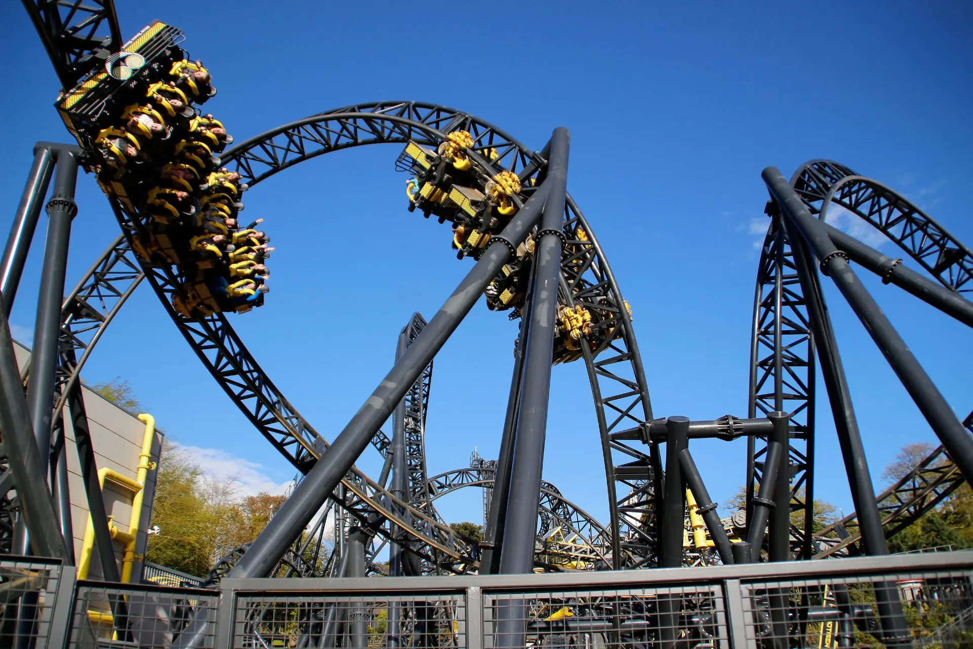 The Smiler's fourteen inversions against a clear blue sky — Alton Towers in Staffordshire, England