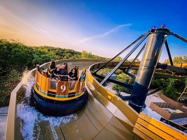 Mystic River Falls raft splashing down at golden hour — Silver Dollar City in Branson, Missouri