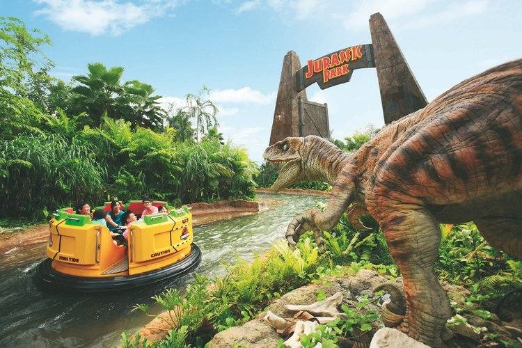 Jurassic Park Rapids Adventure drifting past a raptor — Universal Studios Singapore in Sentosa Island