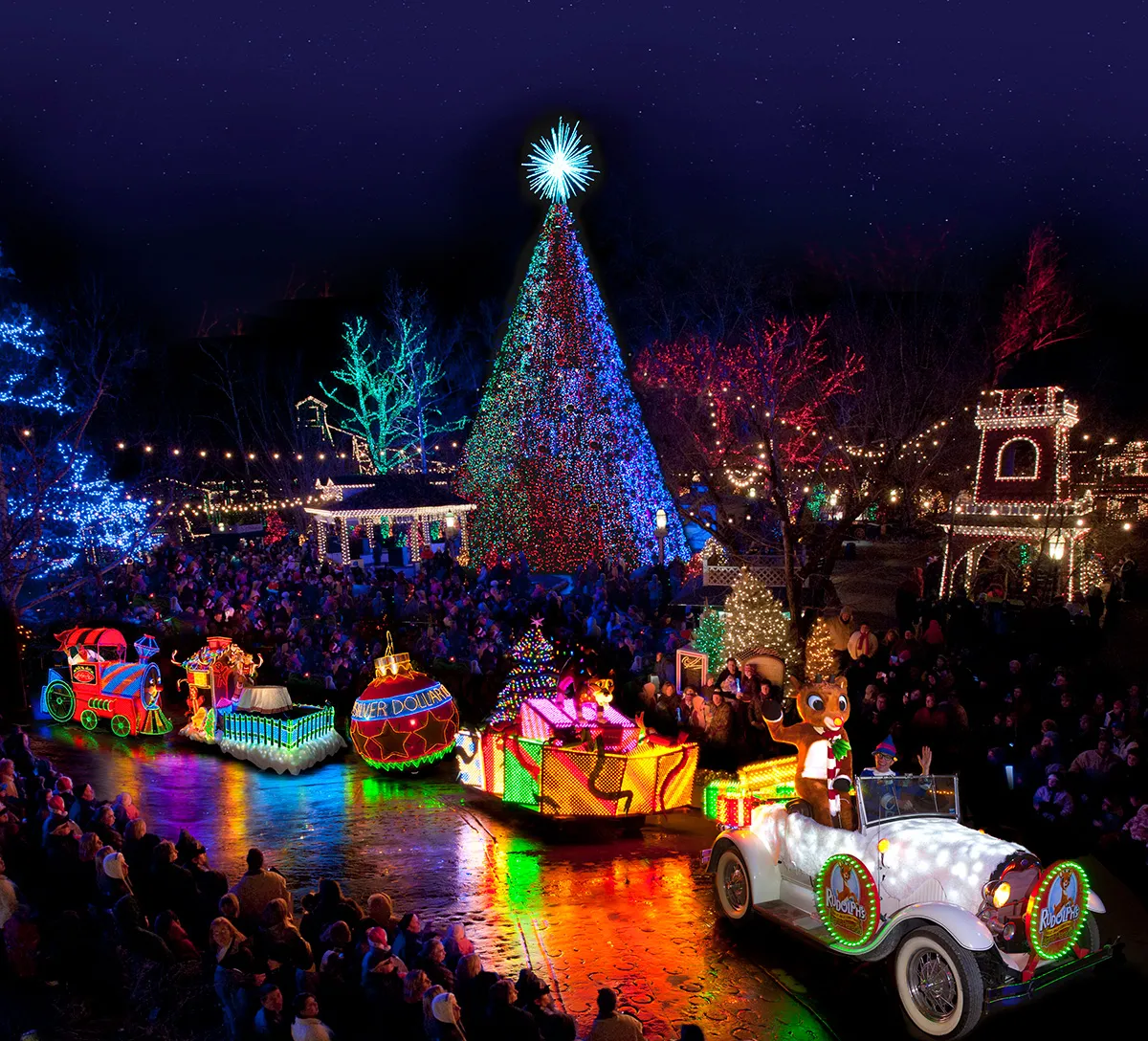 An Old Time Christmas parade glowing beneath the five-story tree — Silver Dollar City in Branson, Missouri