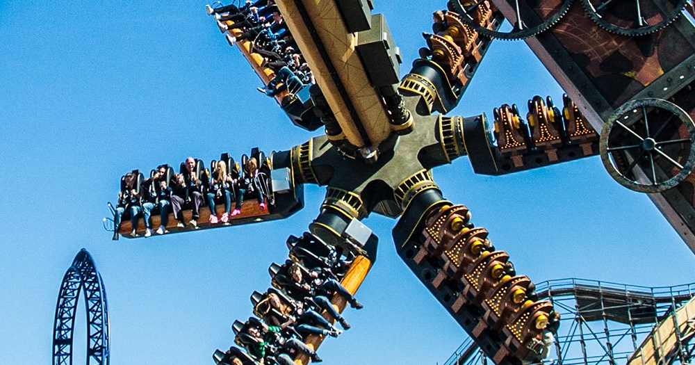 AeroSpin thrill ride spinning against a clear blue sky — Liseberg in Gothenburg