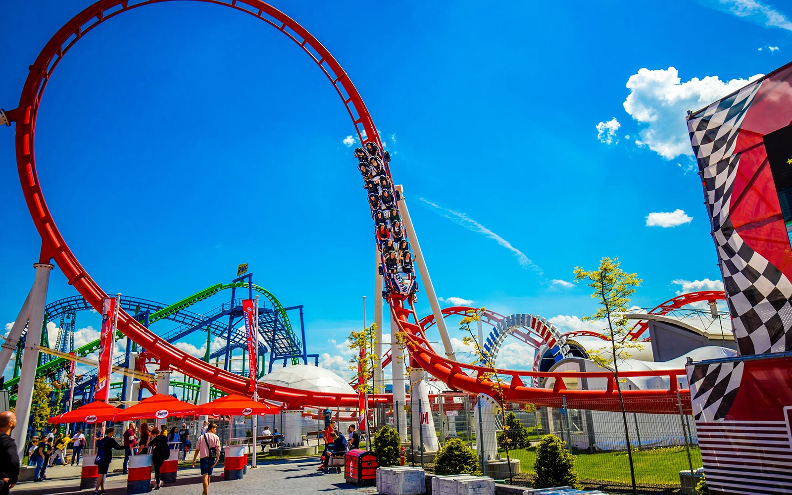 Hyperion and the Formula coaster loop under blue skies at Energylandia