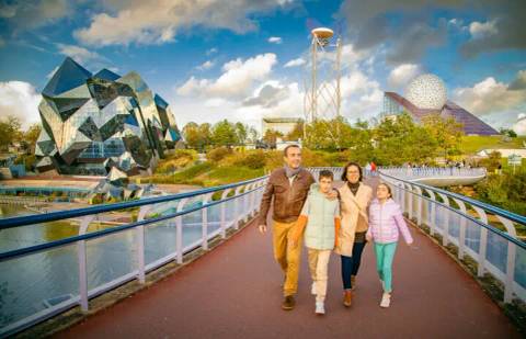 Family Exploring the Futuristic Pavilions of Futuroscope